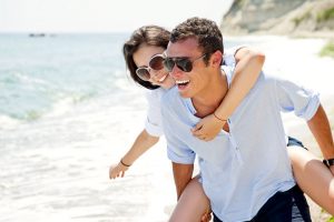 young men and women enjoying on beach